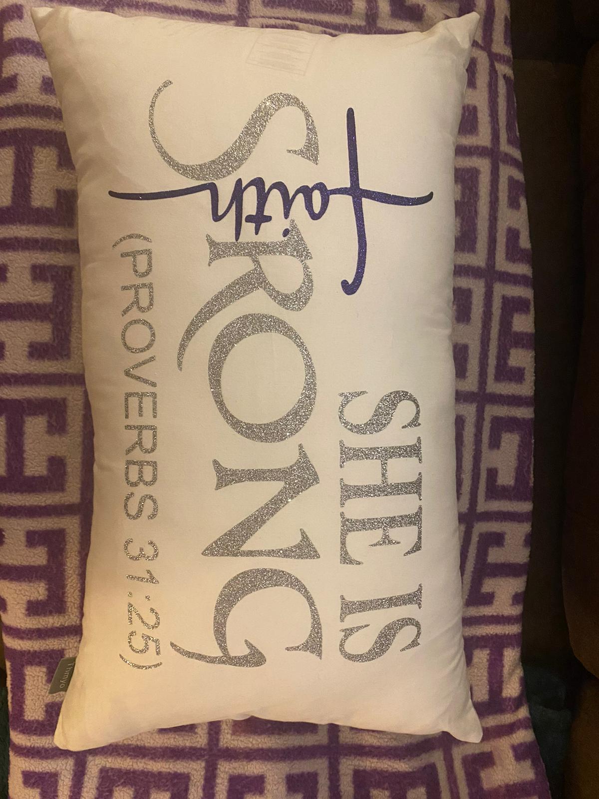 Decorative pillow with motivational text on a patterned background