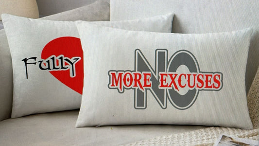 Two pillows with motivational phrases on a couch